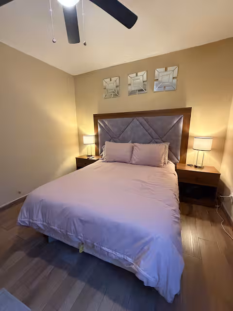 Recámara con cama matrimonial y decoración cálida